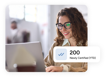 woman types on her laptop behind a tooltip that reads '200 newly certified (YTD)'