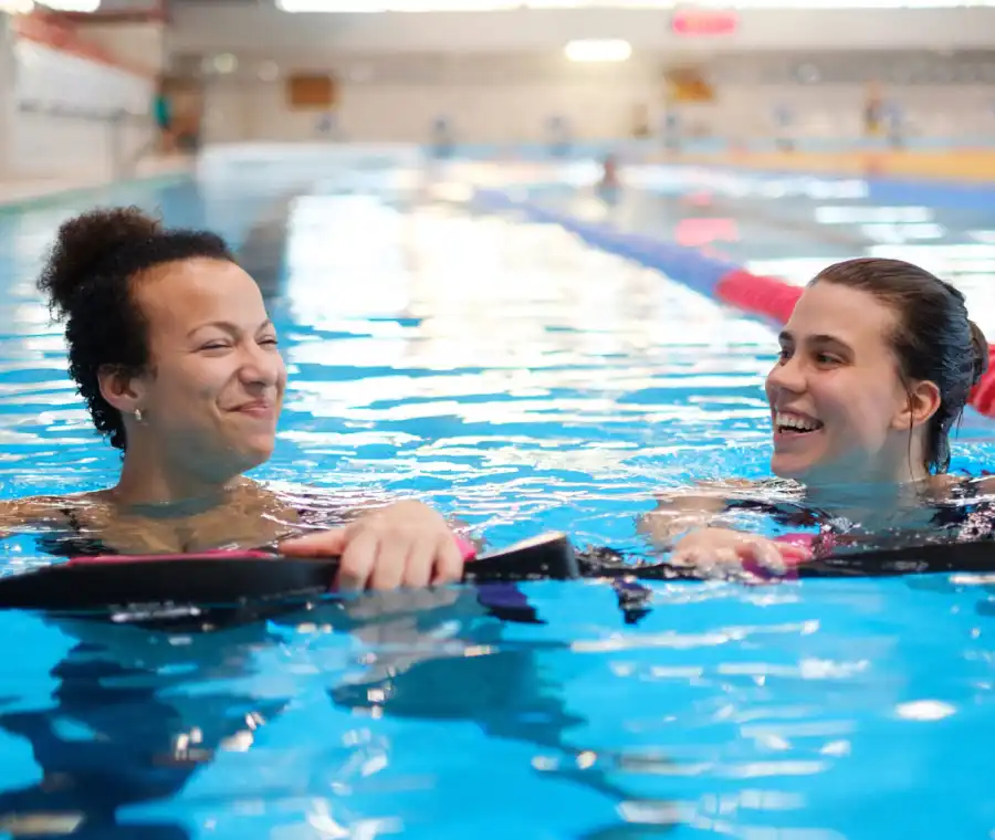 women swim together