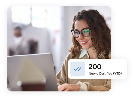 woman types on her laptop behind a tooltip that reads '200 newly certified (YTD)'