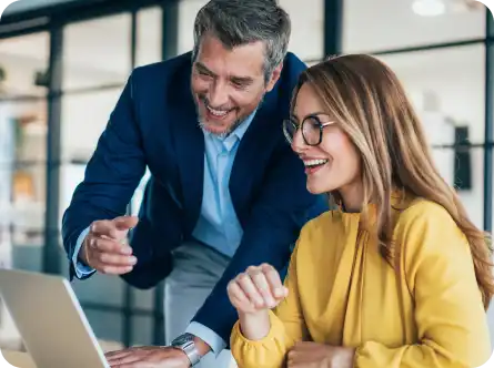 man and woman celebrate a success at work
