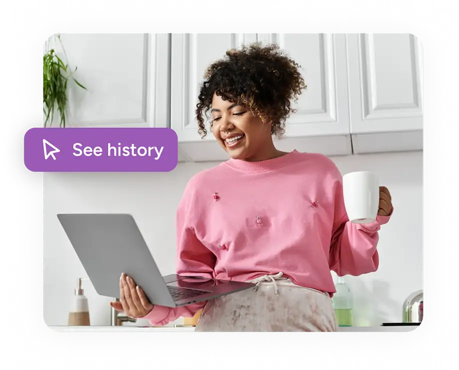 woman holding laptop with button reading see history
