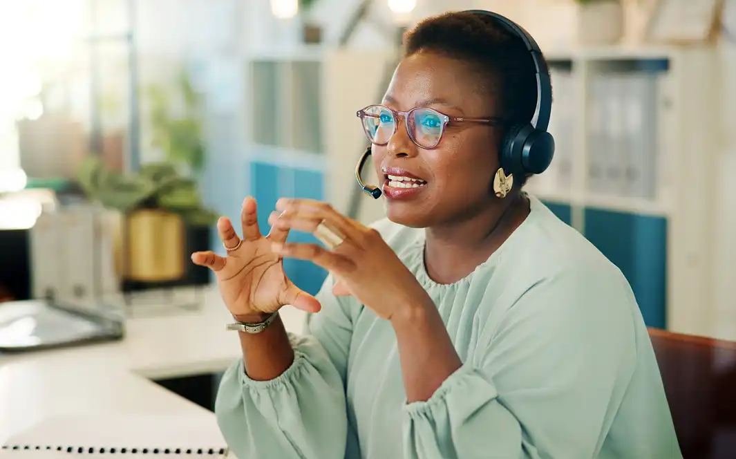 woman with headset talks to a customer