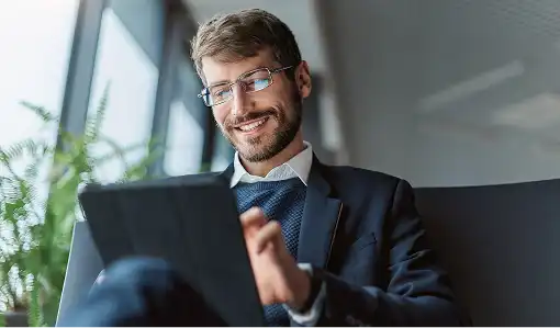 man in a business suit uses a tablet