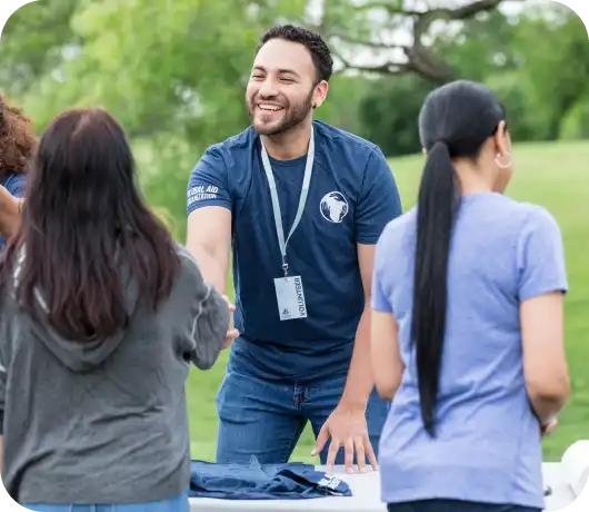 a handshake at the registration table for an outdoor event
