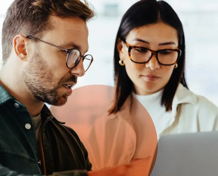 man and woman meeting behind a computer