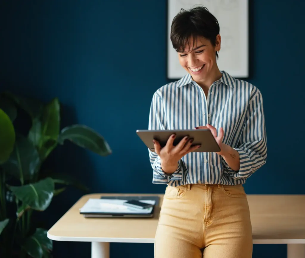 woman uses tablet computer at her desk